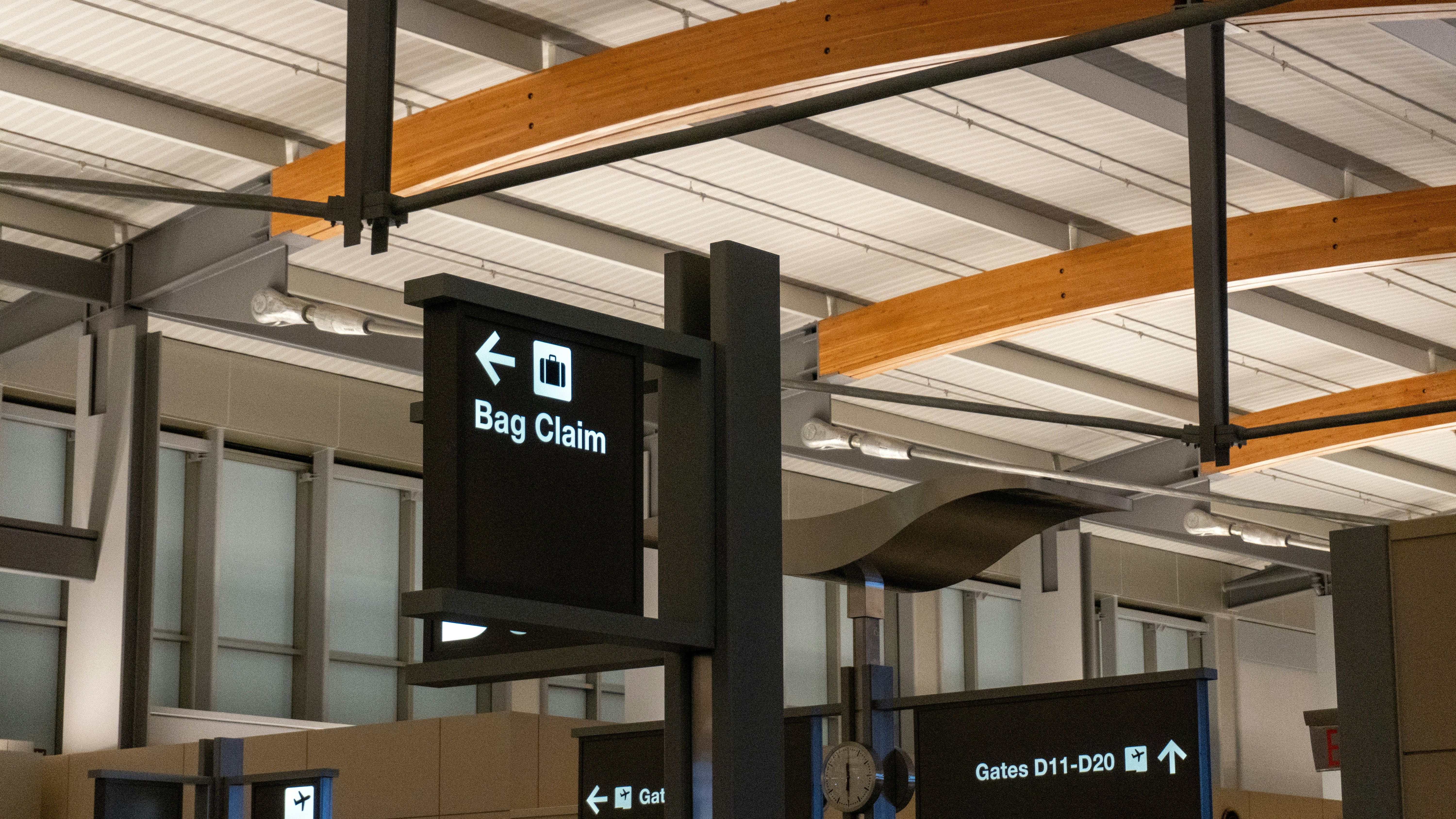 Traveler checking baggage fees at the airport counter.