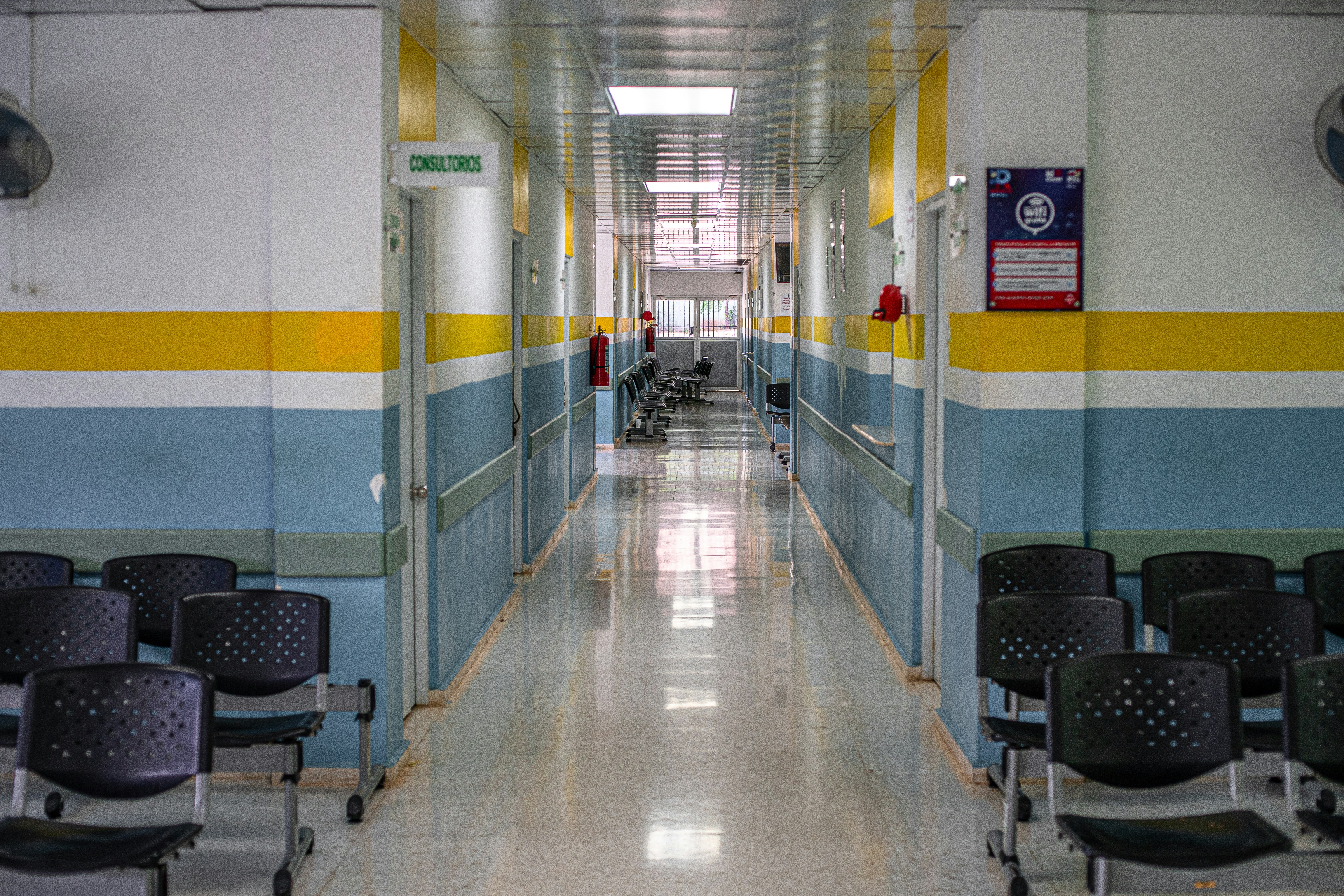 A simple rural hospital bed in Asia with an IV drip, illustrating the need for medical coverage abroad
