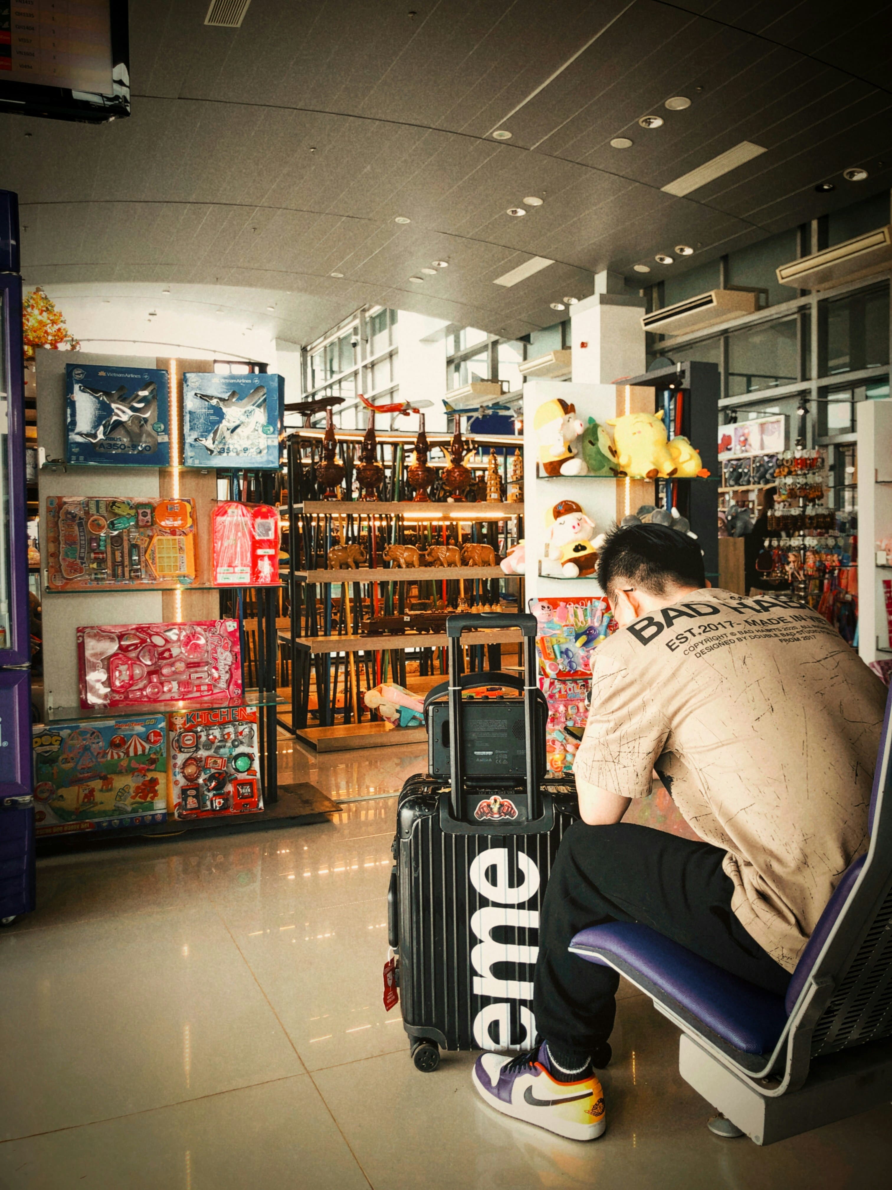 Traveler walking easily through airport with light luggage.