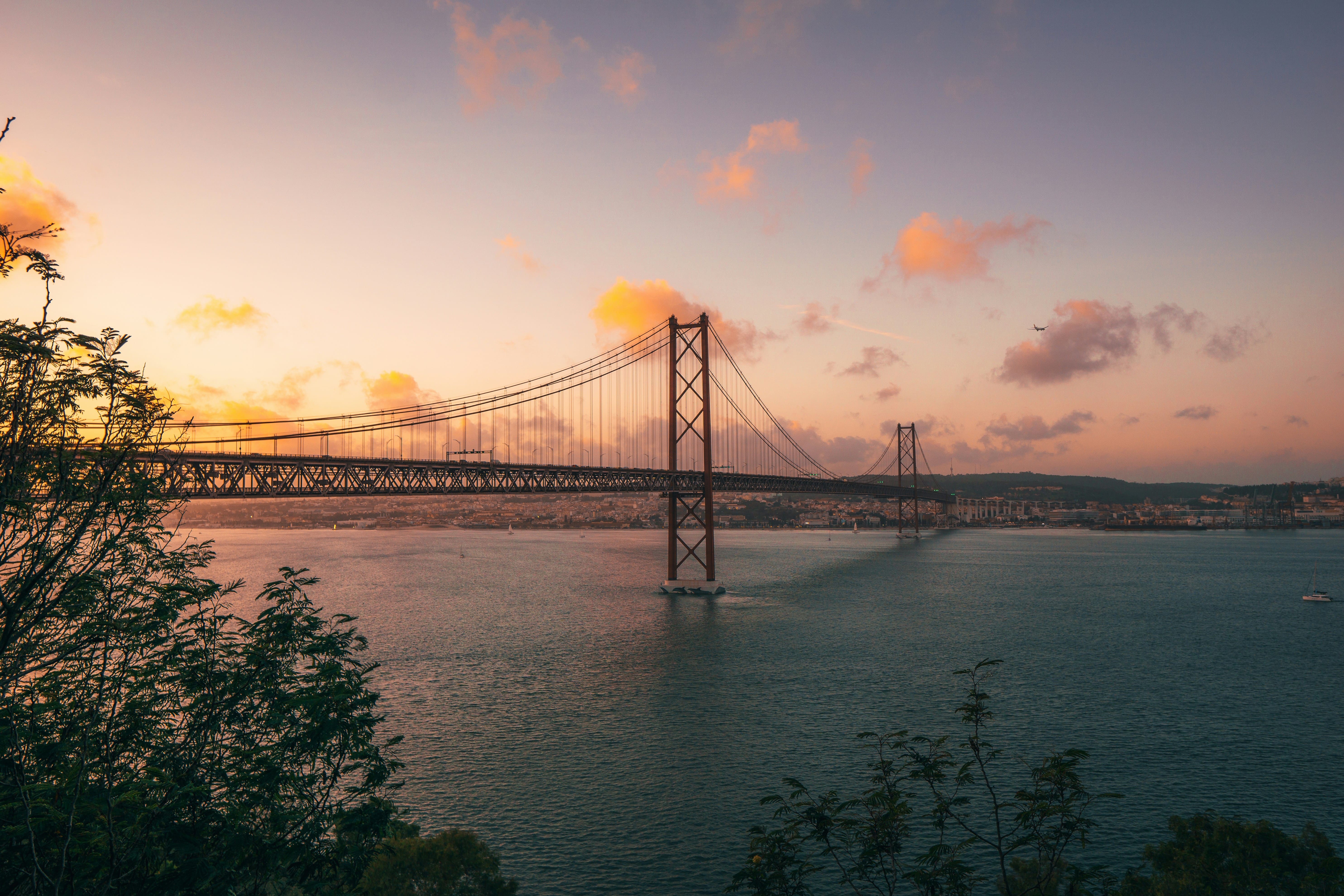 Golden sunset view over Lisbon rooftops and the Tagus River