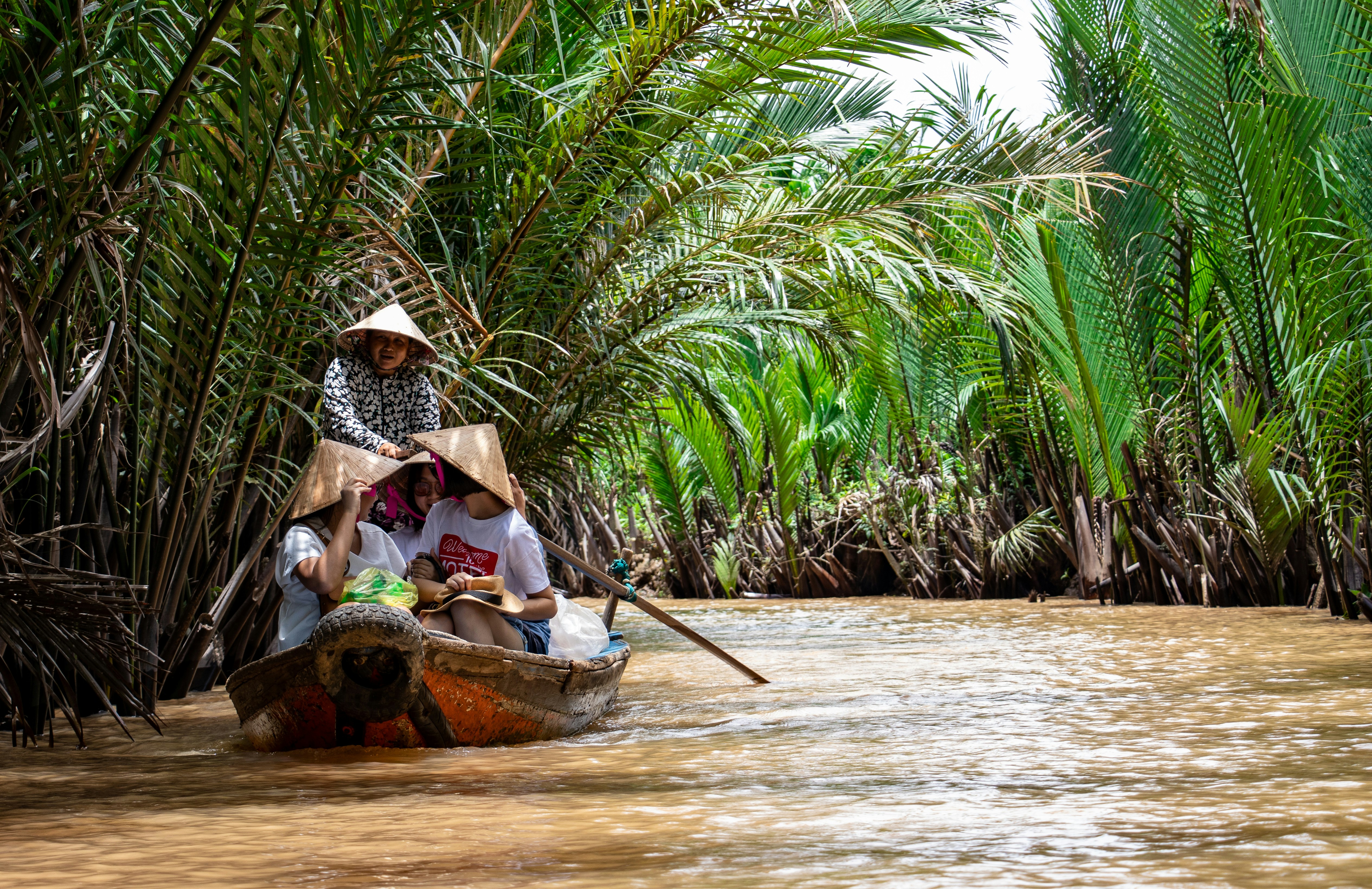 Golden sunset over the Mekong River with traditional long-tail boats in Laos