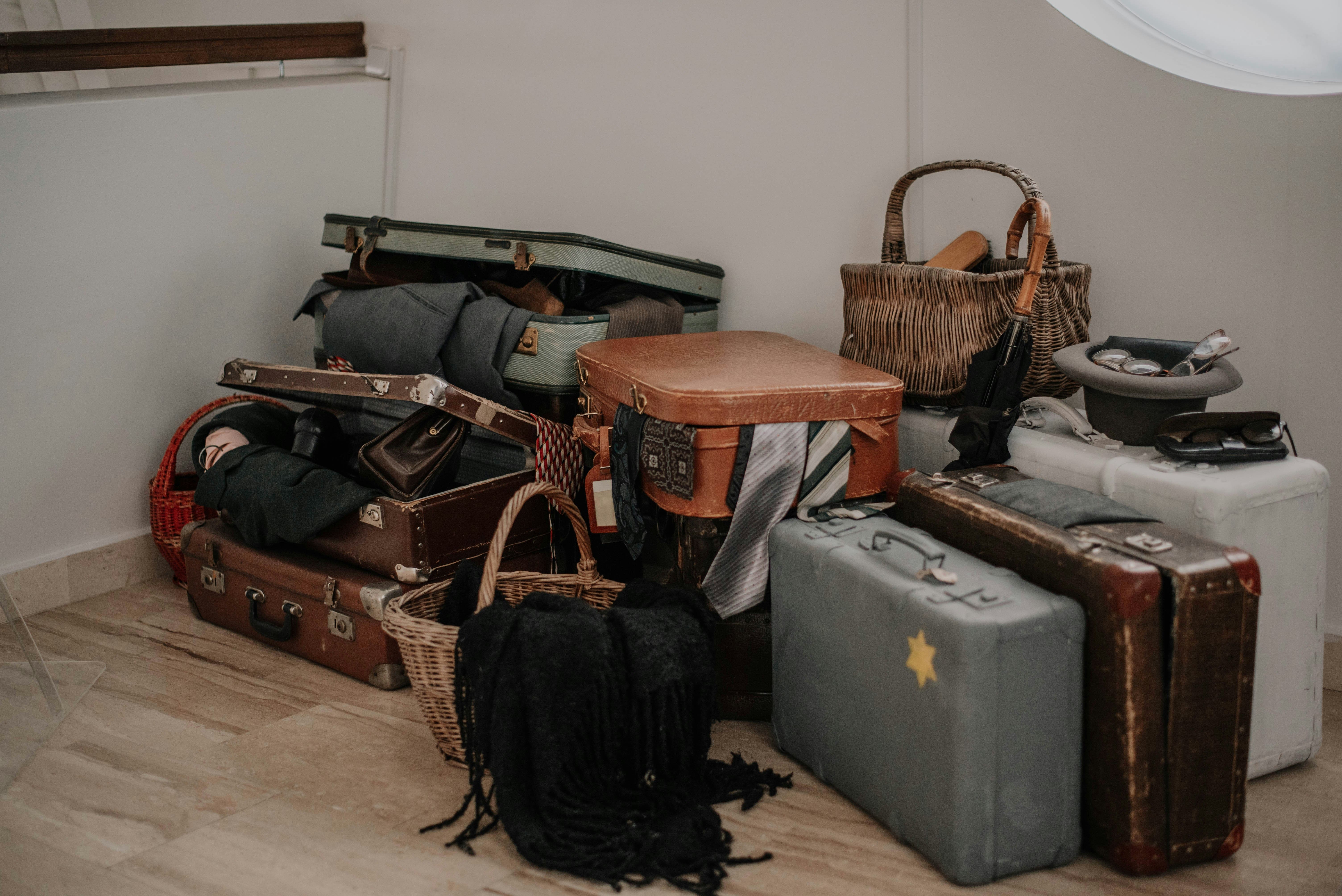 Traveler struggling with overpacked luggage at the airport.