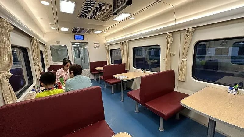 Vista interior da cabine dormitório de Segunda Classe no trem de Bangkok para Chiang Mai com a cortina de privacidade fechada, mostrando um espaço aconchegante e reservado.