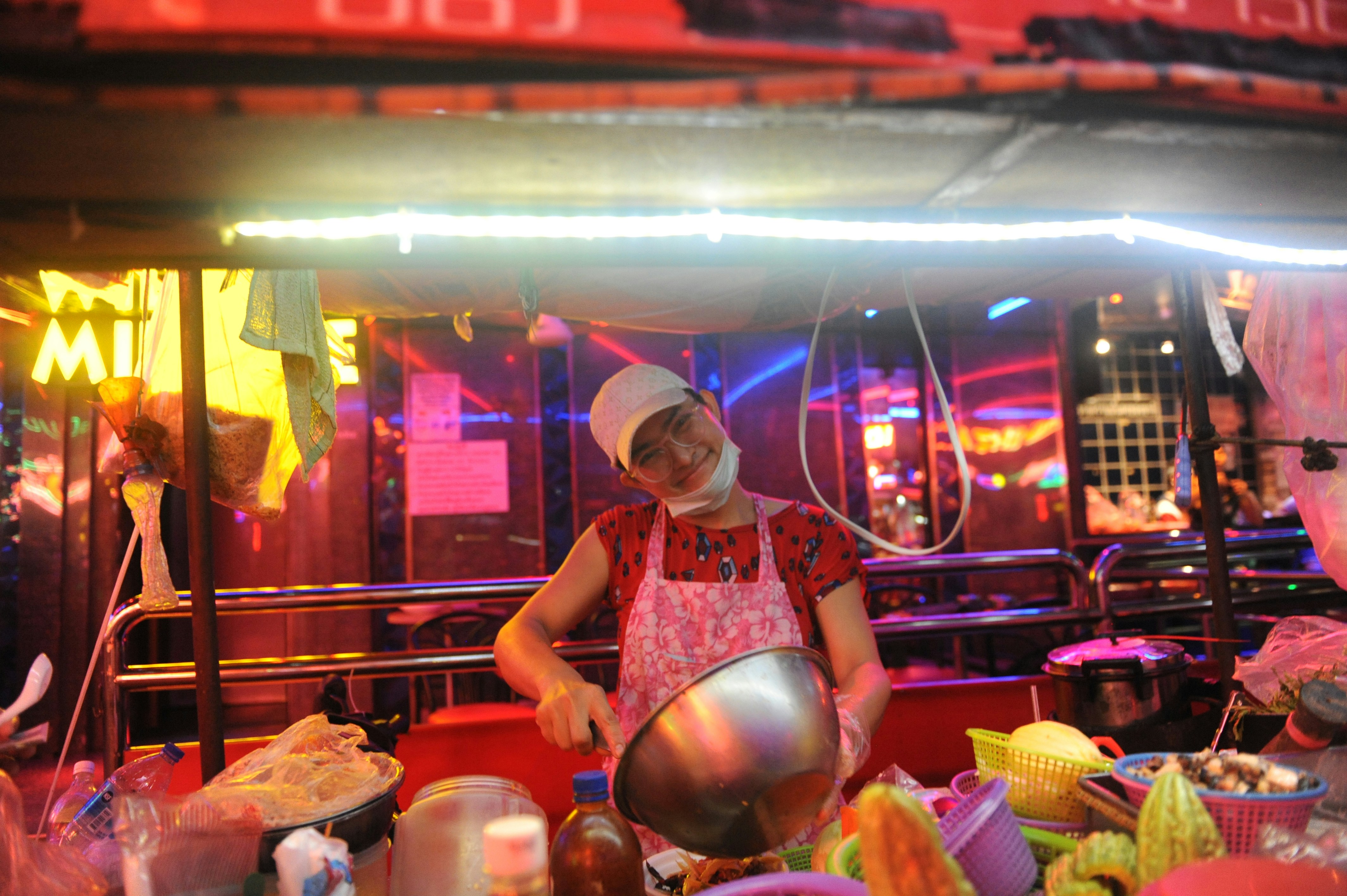 Steaming bowls of boat noodle soup at a bustling street stall in Bangkok, Thailand