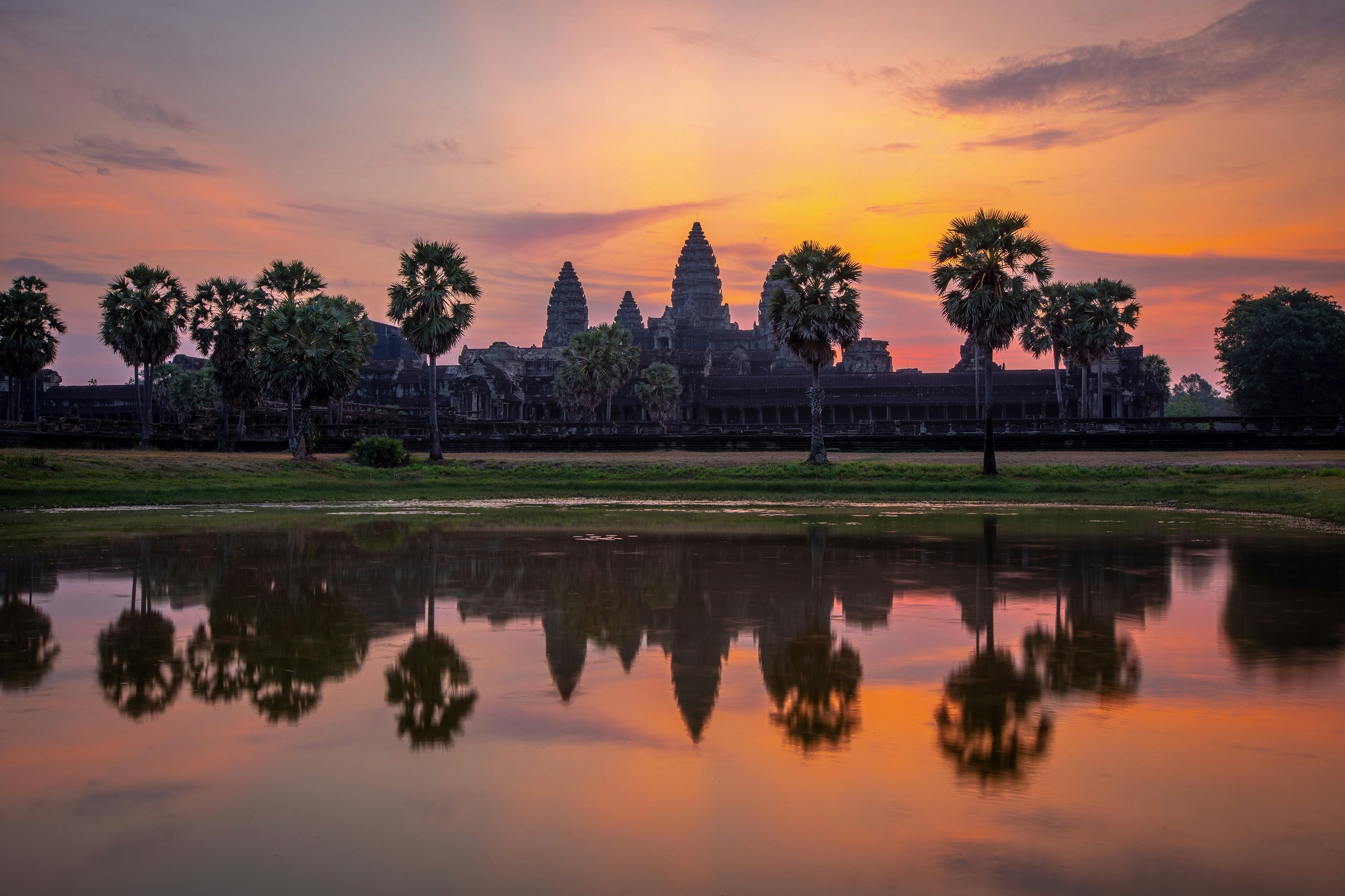 Stunning sunrise silhouette of Angkor Wat temple with a perfect reflection in the water