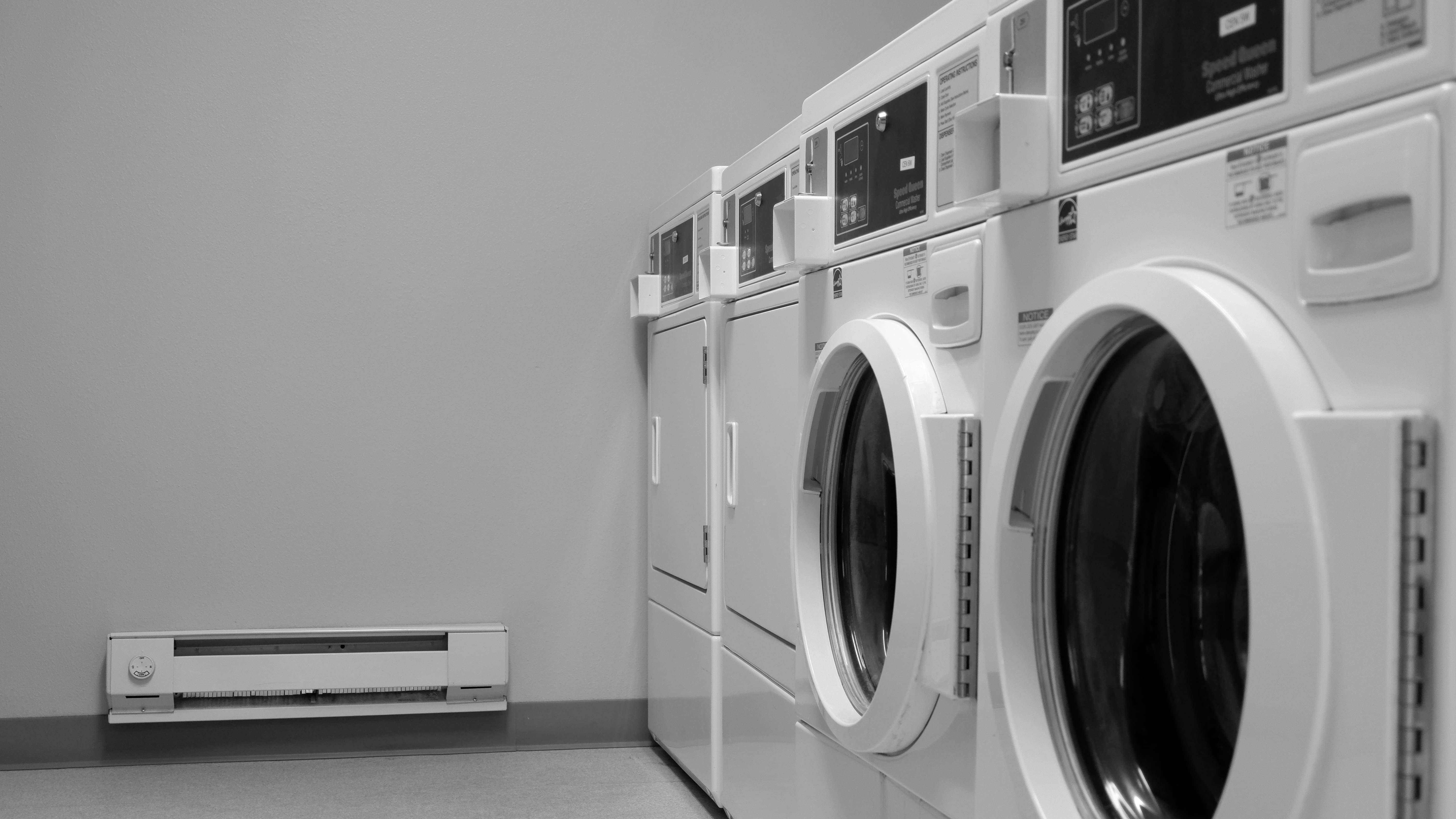 Traveler handwashing clothes in a hotel sink using travel detergent.